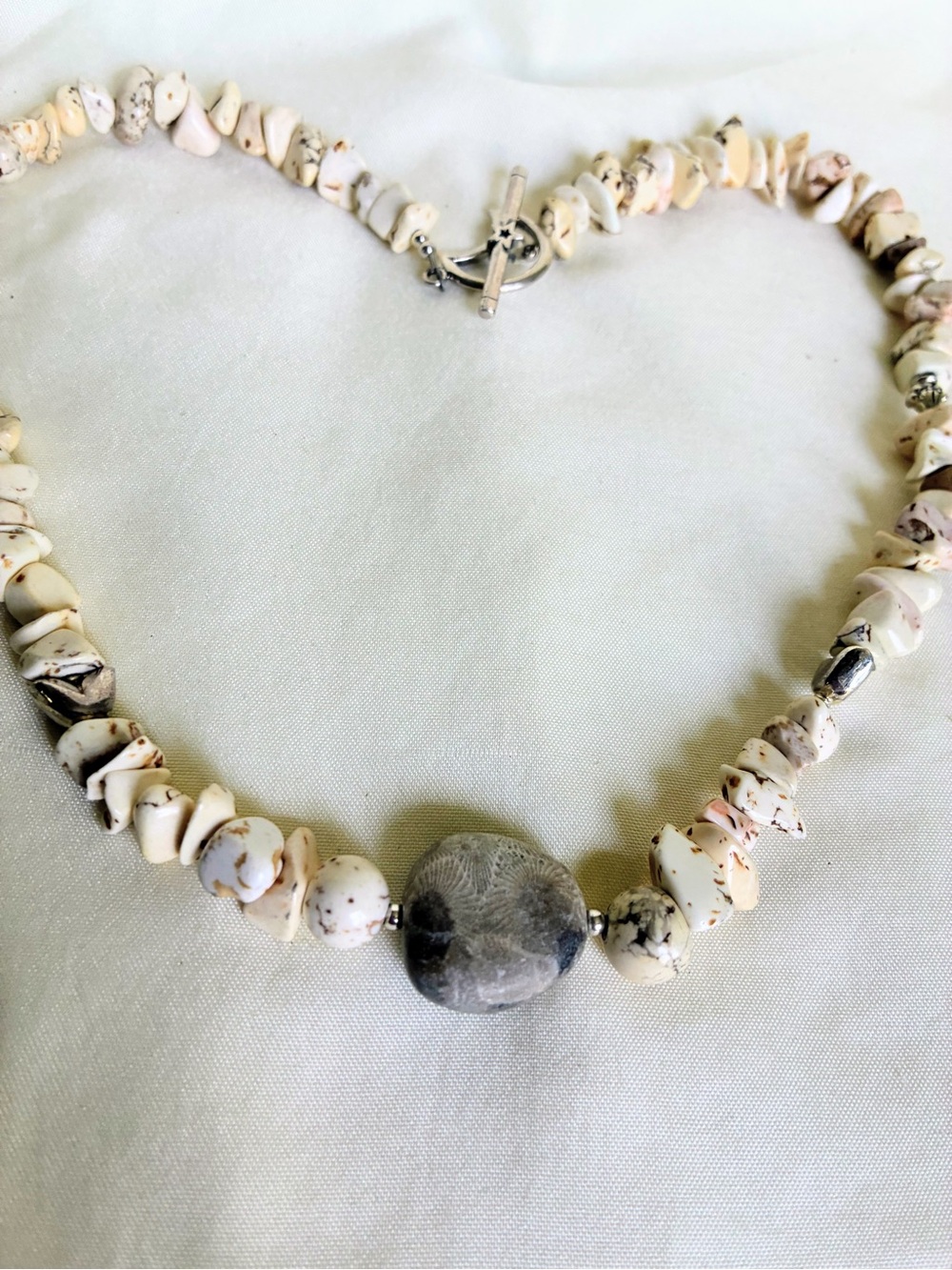 Handmade necklace with howlite beads a and Petoskey Stone in the middle #handmad